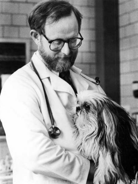 Dr. William Hornbuckle holding a dog, 1987.