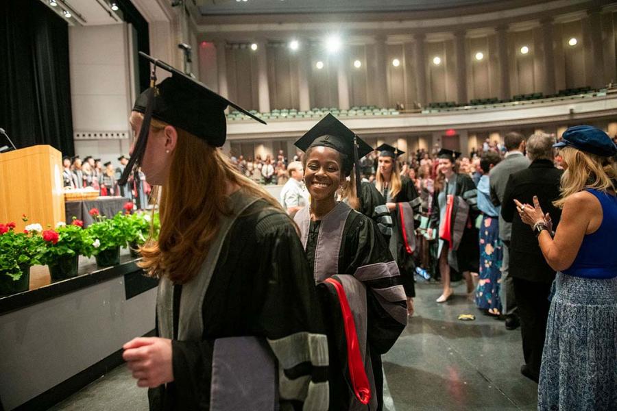 Students walking during hooding ceremony