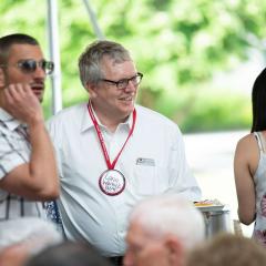 Dean Warnick smiles with guests at the CVM bar-be-que