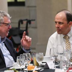 Dr. Cote in conversation with Dean Warnick at dinner