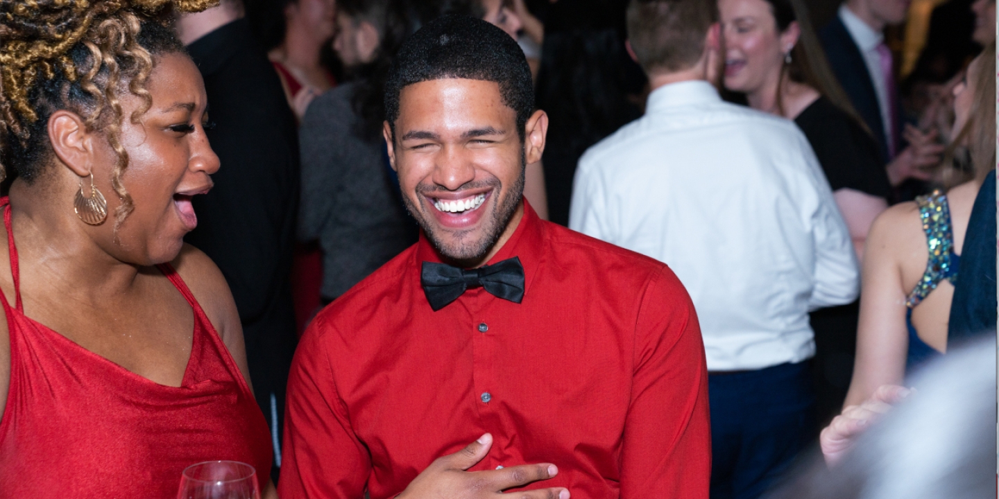 Two students laughing at a party