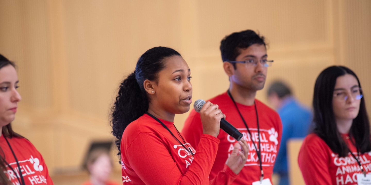  A student talk in a microphone giving a presentation to an audience
