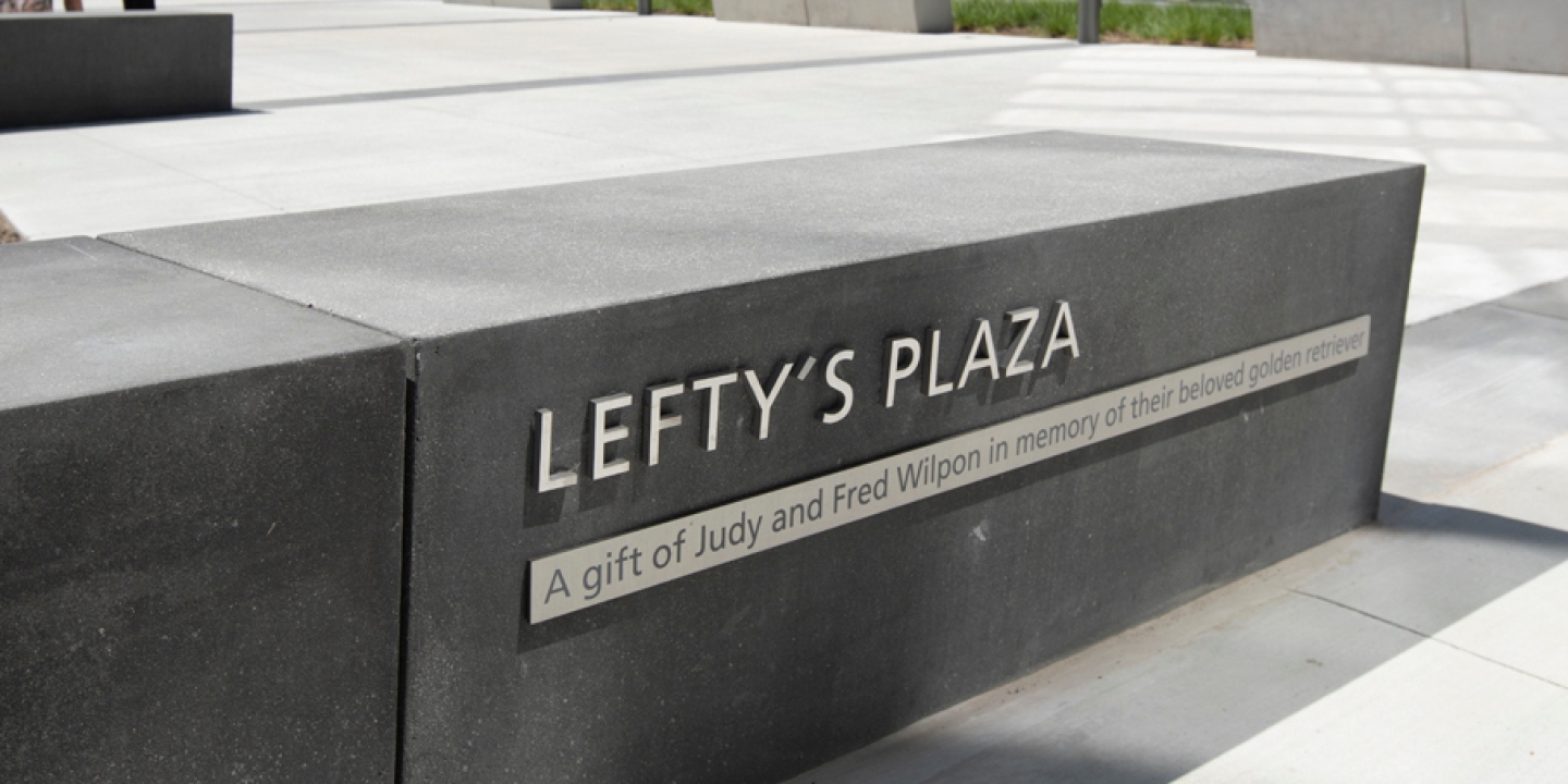Outdoor bench with the engraved words lefty's plaza