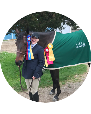 A person next to a horse with ribbons
