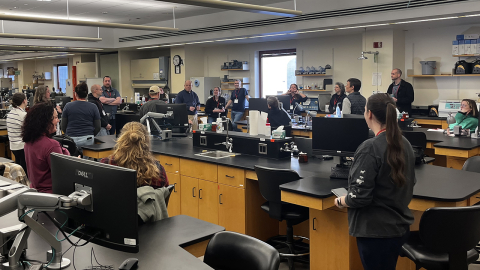 Dairy experts gathered in a lab for mastitis testing training