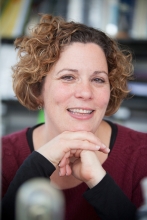 Paula Cohen in dark red shirt with black sleeves