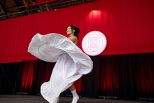 Student in white dancing on stage