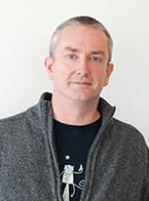 A professional portrait image of Dr. Chris Hunter.