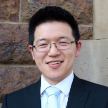Meng Wang wearing a suit.