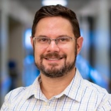 A professional portrait image of Dr. Paul Thomas.