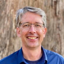 A professional portrait image of Dr. Russell Vance.