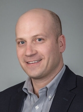 A professional portrait image of Dr. Scott Hensley.