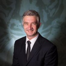 Pierre Comizzoli wearing a suit.