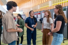 students laughing at a poster session