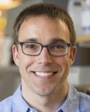 A professional portrait image of Dr. Jeremy Rock.