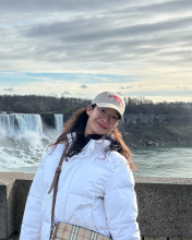Jooyoung Park smiling infront of a waterfall 
