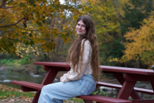 Emma Kosmeder smiling on bench
