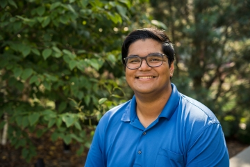 Viraj Upadhye, man in blue shirt with glasses