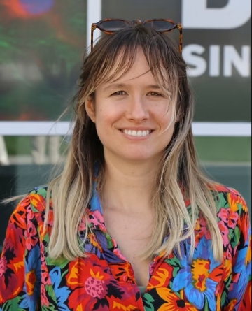 Anna Kolarzyk smiling with hair blowing in wind