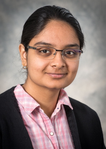 Maithili Deshpande in a pink shirt and black sweater