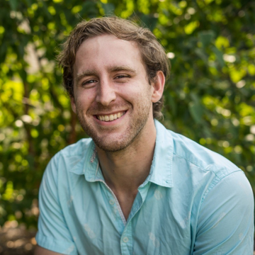 Alexander McGurk smiling in blue shirt