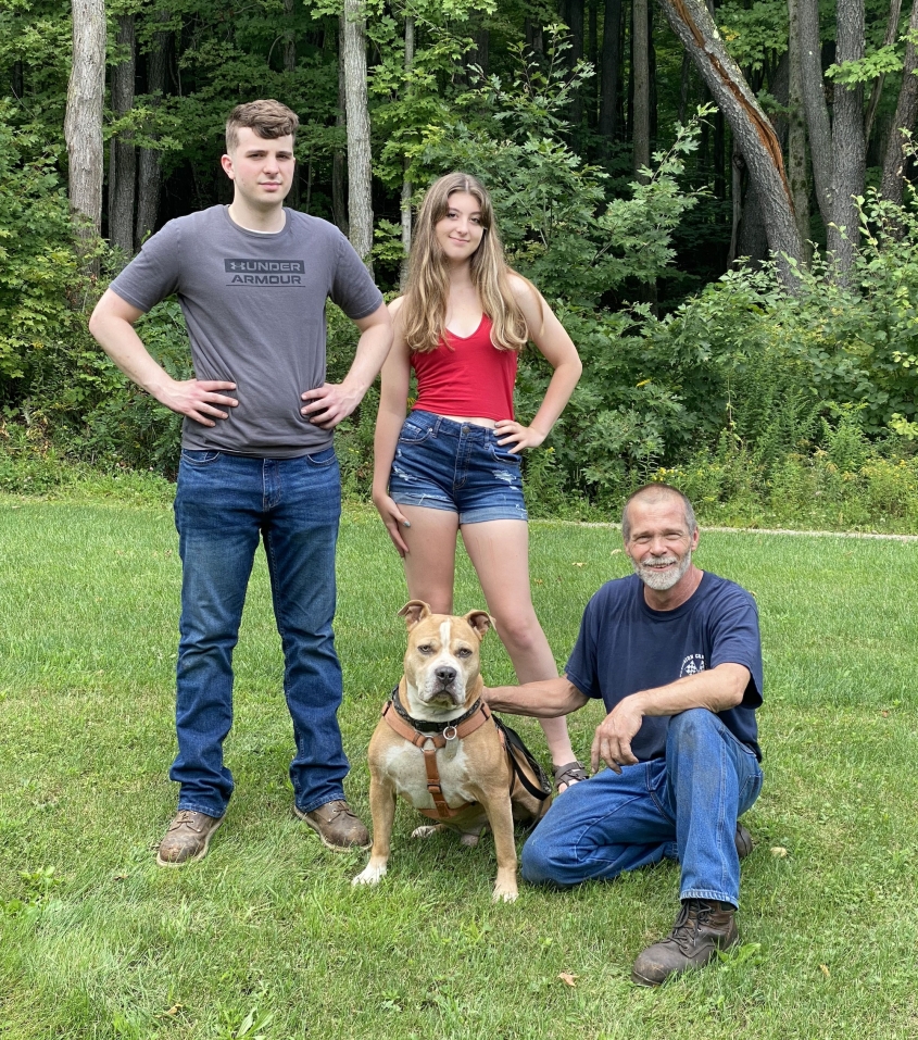 Gage on grass with family