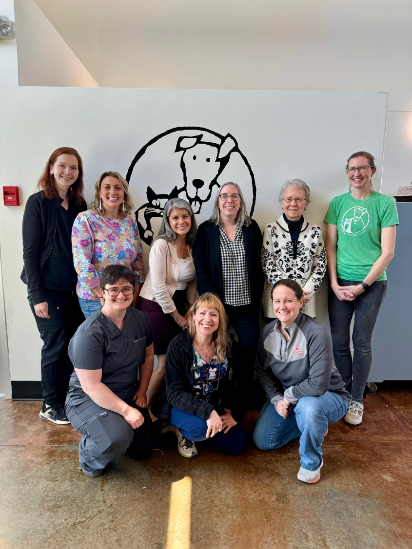 Maddie's Shelter team posed in front of MSMP logo