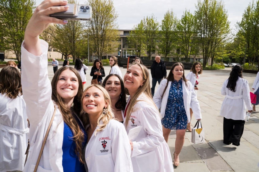 Veterinary students taking selfie in white coats