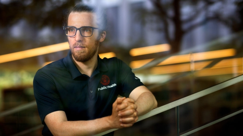 Alistair Hayden looking through a window