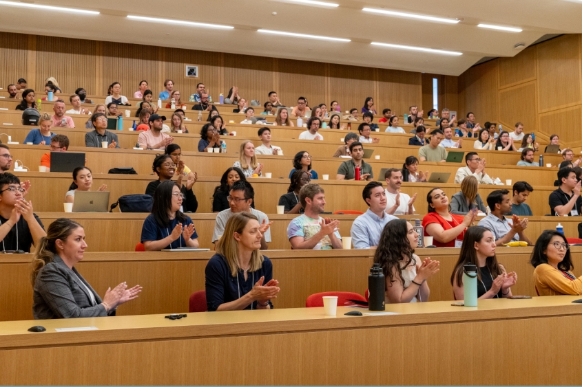 People clapping in a lecture hall
