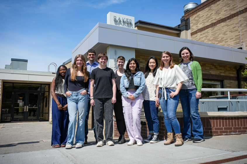 Members of the Evans Lab stand in front of the Baker Institute for Animal Health