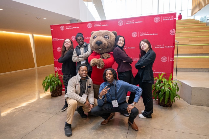winning team of students posing with Touchdown the bear mascot