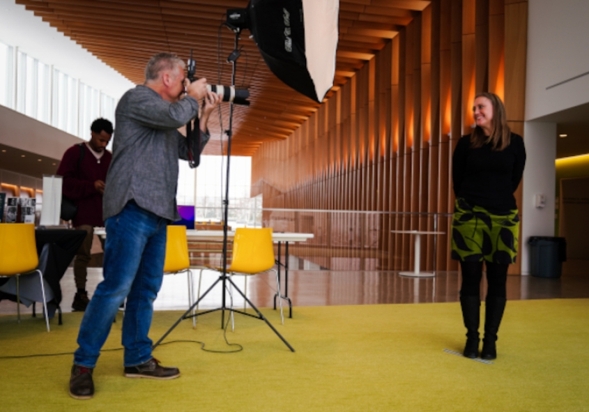A photographer taking a picture of a woman