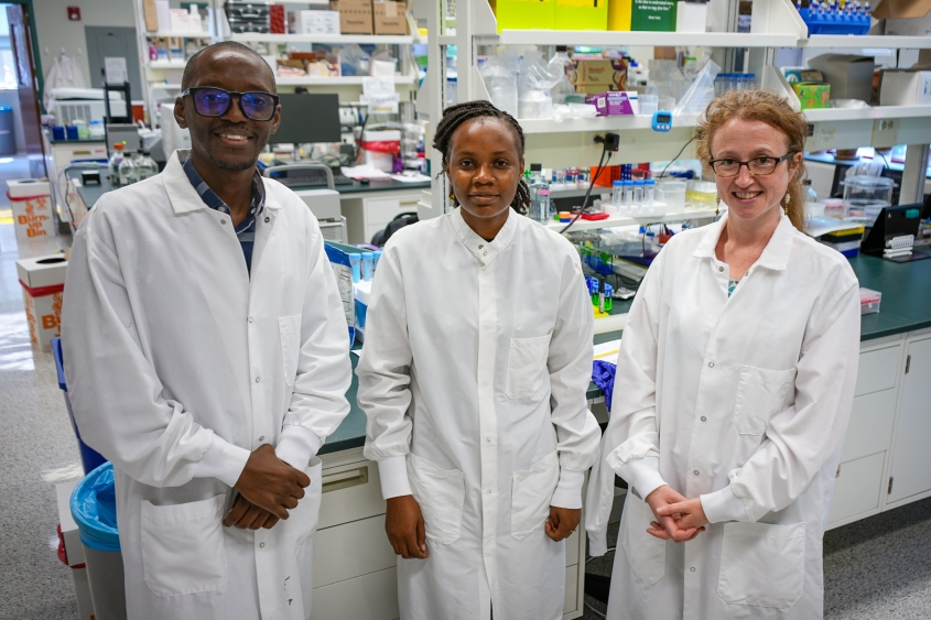 Three scientists stand in a lab at the Baker Institute 
