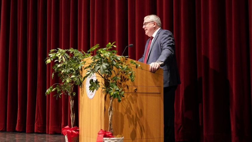 Dean Lorin Warnick speaking at a podium