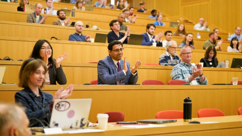 Audience in lecture hall applauding