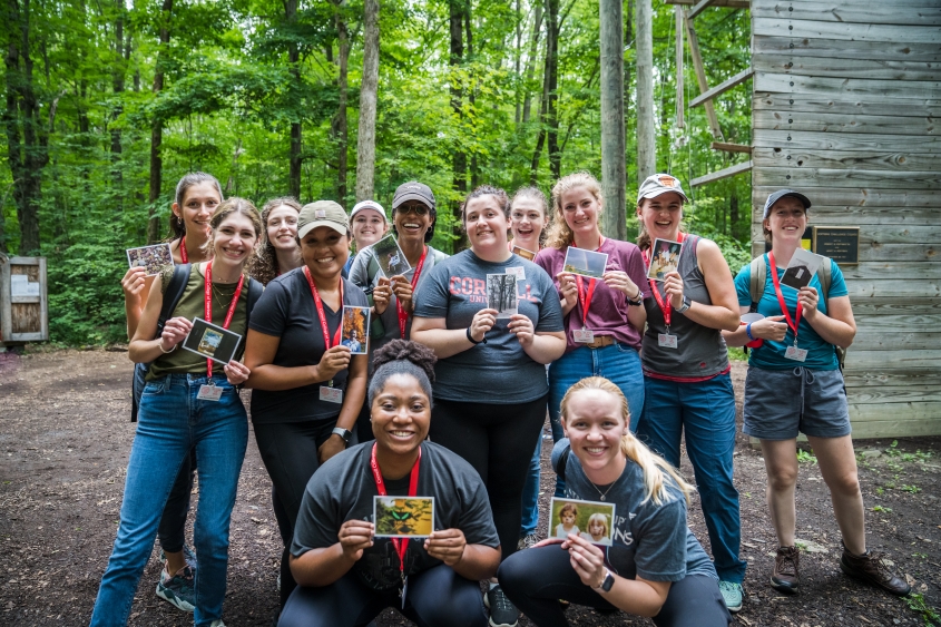 Several members of the DVM Class of 2026  hold a card as part of a team leadership activity.