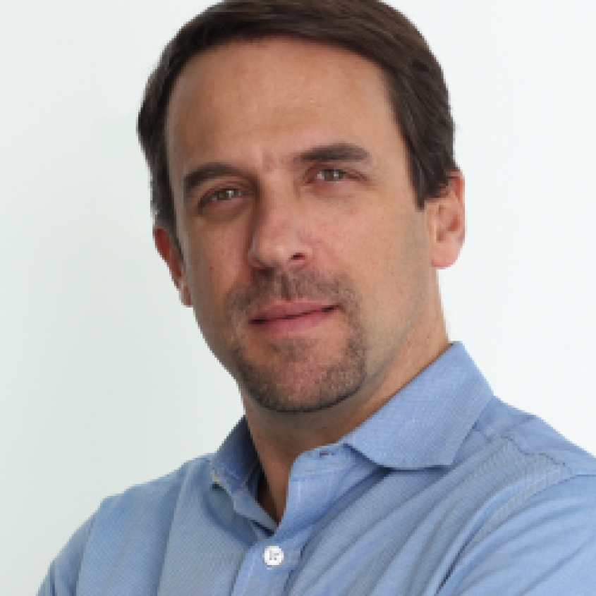 Marcus Smolka wearing a light blue collared shirt.