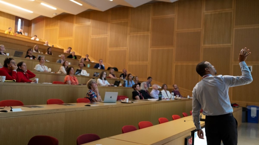 Speaker presenting to a lecture hall audience