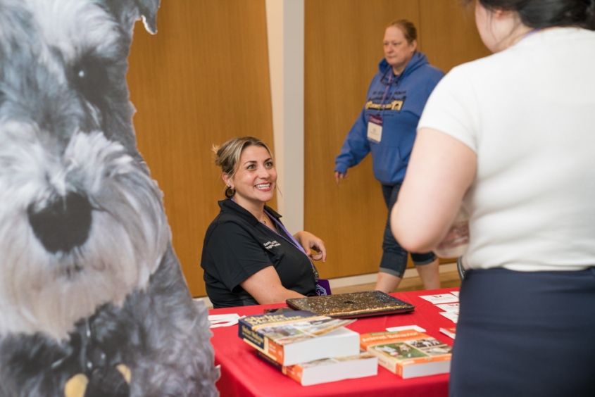 Suzette Moschetti at a table during the conference