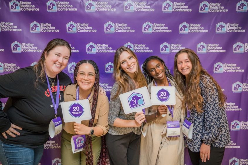 A group of people posing for a picture at a conference