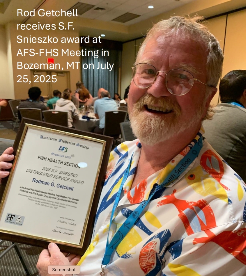 Rod Getchell holding S.F. Snieszko Distinguished Service Award