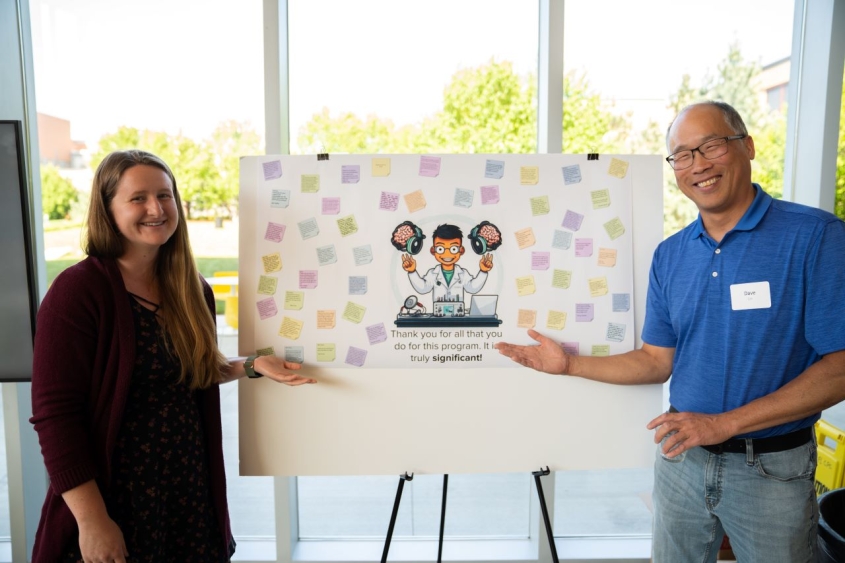David Lin and student standing next to a poster