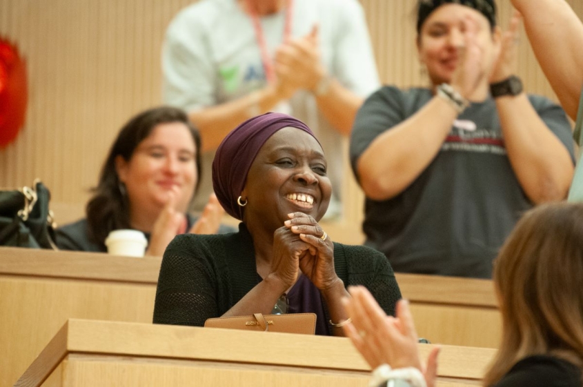 Jarra Jagne smiling among an audience of clapping people