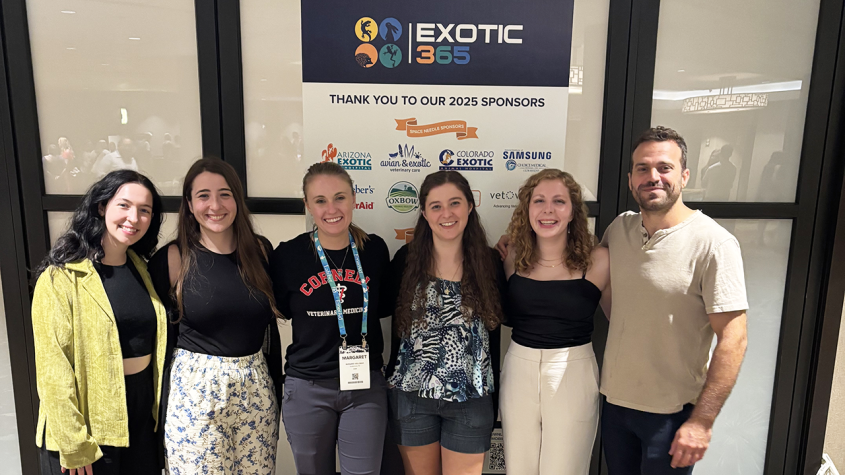 A group of exotics team members grouped at a conference
