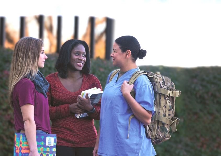 Three people stand outdoors, one in scrubs with a backpack and the other two holding books and notebooks.