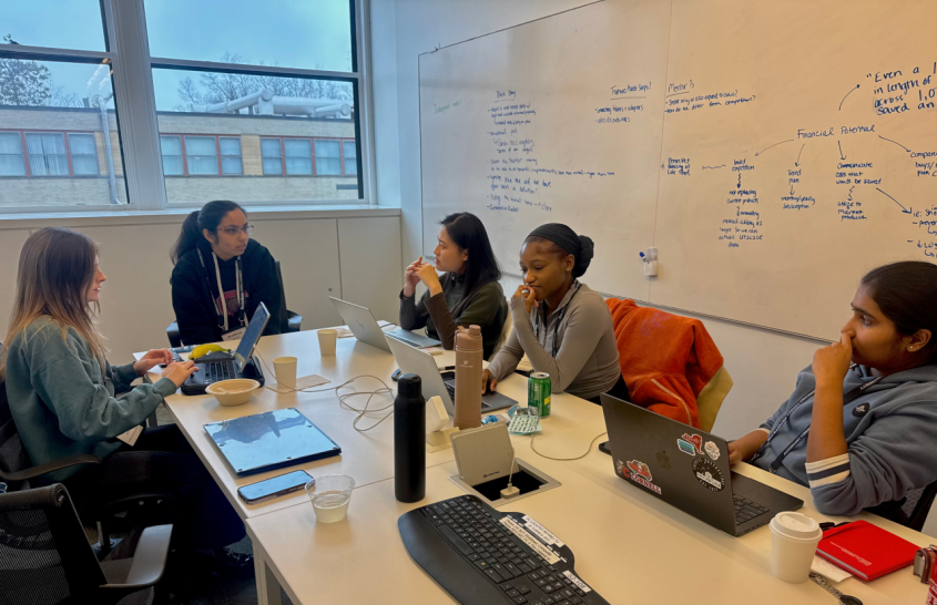 Small group of students discussing a project in a classroom