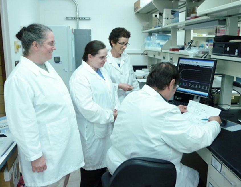 The coagulation team around a lab bench examining a sample