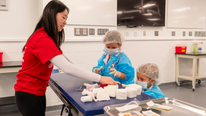 A veterinarian playing with kids disguised as doctors