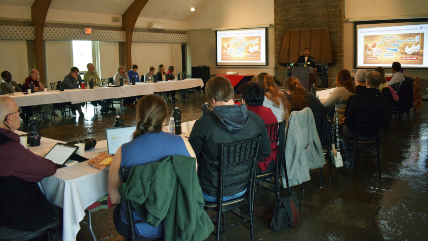 A presenter at Moakley House to a U-shaped table